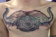 Black and grey elephant and mandala chest piece tattoo